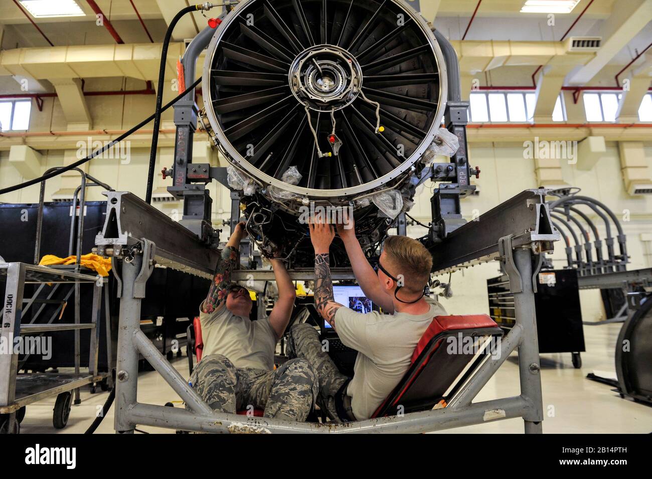 U.S. Airmen assigned to the 18th Component Maintenance Squadron repair and engine from an F-15 Eagle aircraft Oct. 12, 2018, at Kadena Air Base, Japan. The 18th CMS maintains spare engines for Kadena Air Base’s fleet of F-15 Eagles, ensuring there are enough assets to back up the aircraft in case of an engine malfunction. (U.S. Air Force photo by Naoto Anazawa) Stock Photo