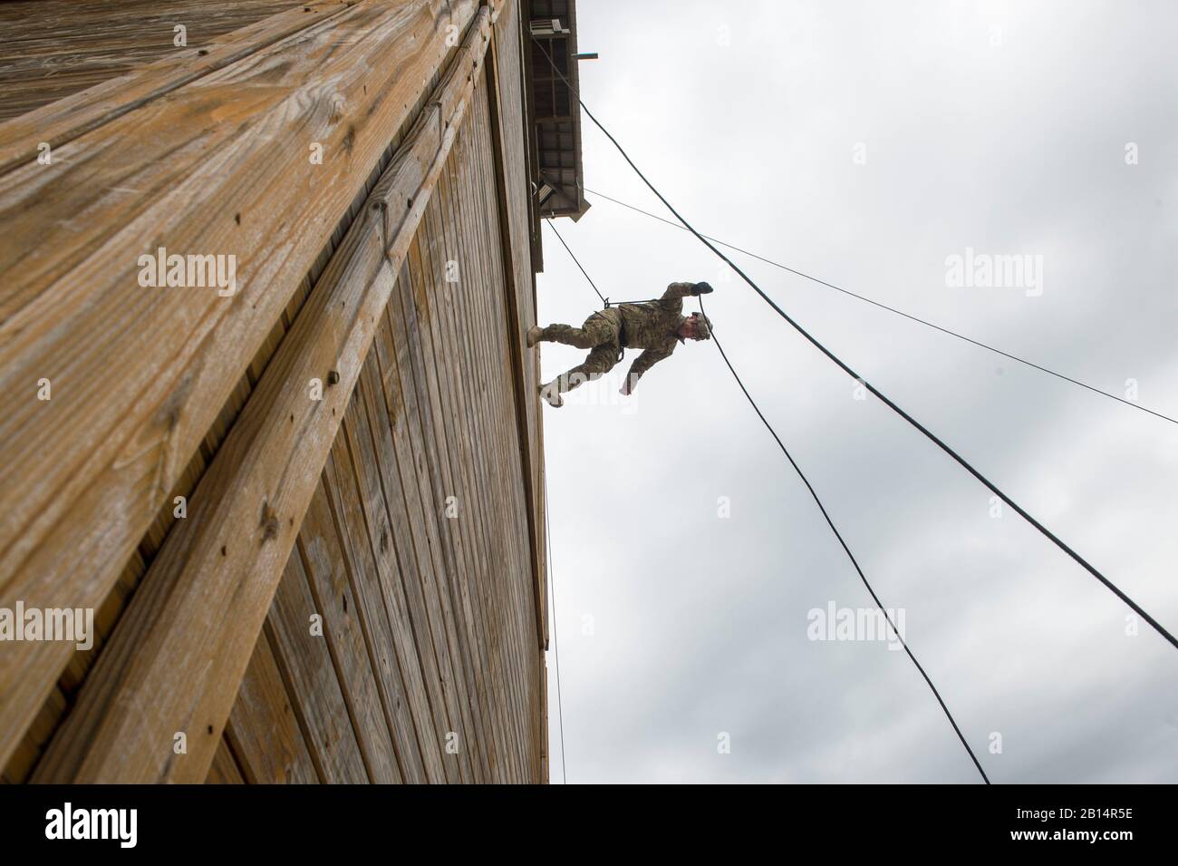 A U.S. Navy explosive ordnance disposal technician assigned to Explosive Ordnance Disposal Group (EODGRU) 2 conducts an “Australian” rappel during helicopter rope suspension technique (HRST) training at Joint Expeditionary Base Little Creek-Fort Story, Va., March 19, 2018. EODGRU 2 is headquartered at Joint Expeditionary Base Little Creek-Fort Story and oversees Mobile Diving and Salvage Unit (MDSU) 2 and all east coast based EOD mobile Units. (U.S. Navy photo by Mass Communication Specialist 1st Class Jeff Atherton) Stock Photo