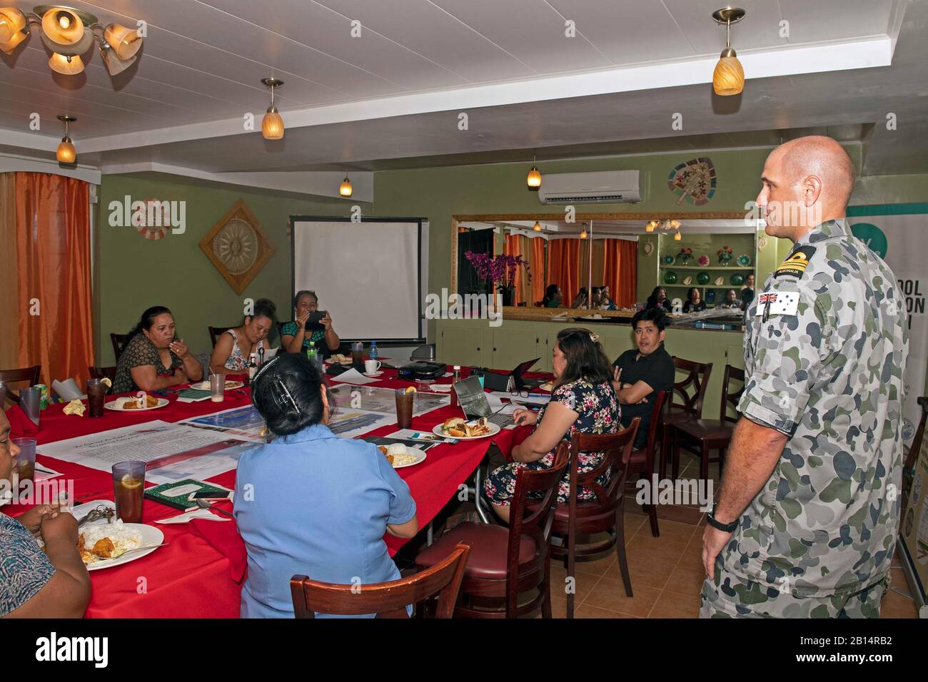 Royal Australian Navy Lt. Cmdr. David Chapman discusses United Nations’ Women, Peace and Security Agenda during a luncheon with local Marshallese officials at the Marshall Islands Resort during Pacific Partnership 2019 in the Republic of the Marshall Islands, March 19, 2019. Pacific Partnership, now in its 14th iteration, is the largest annual multinational humanitarian assistance and disaster relief preparedness mission conducted in the Indo-Pacific. Each year, the mission team works collectively with host and partner nations to enhance regional interoperability and disaster response capabili Stock Photo