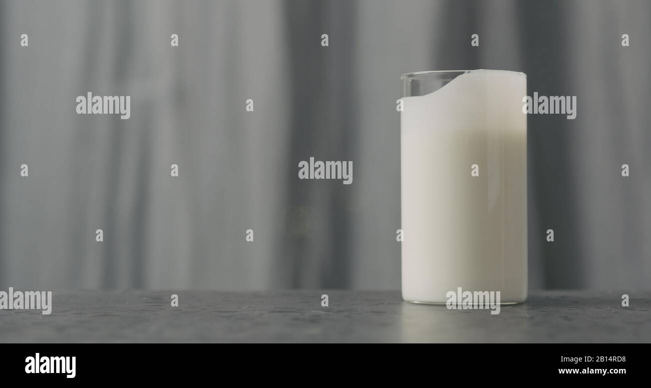 white yogurt in glass on concrete countertop, wide photo Stock Photo