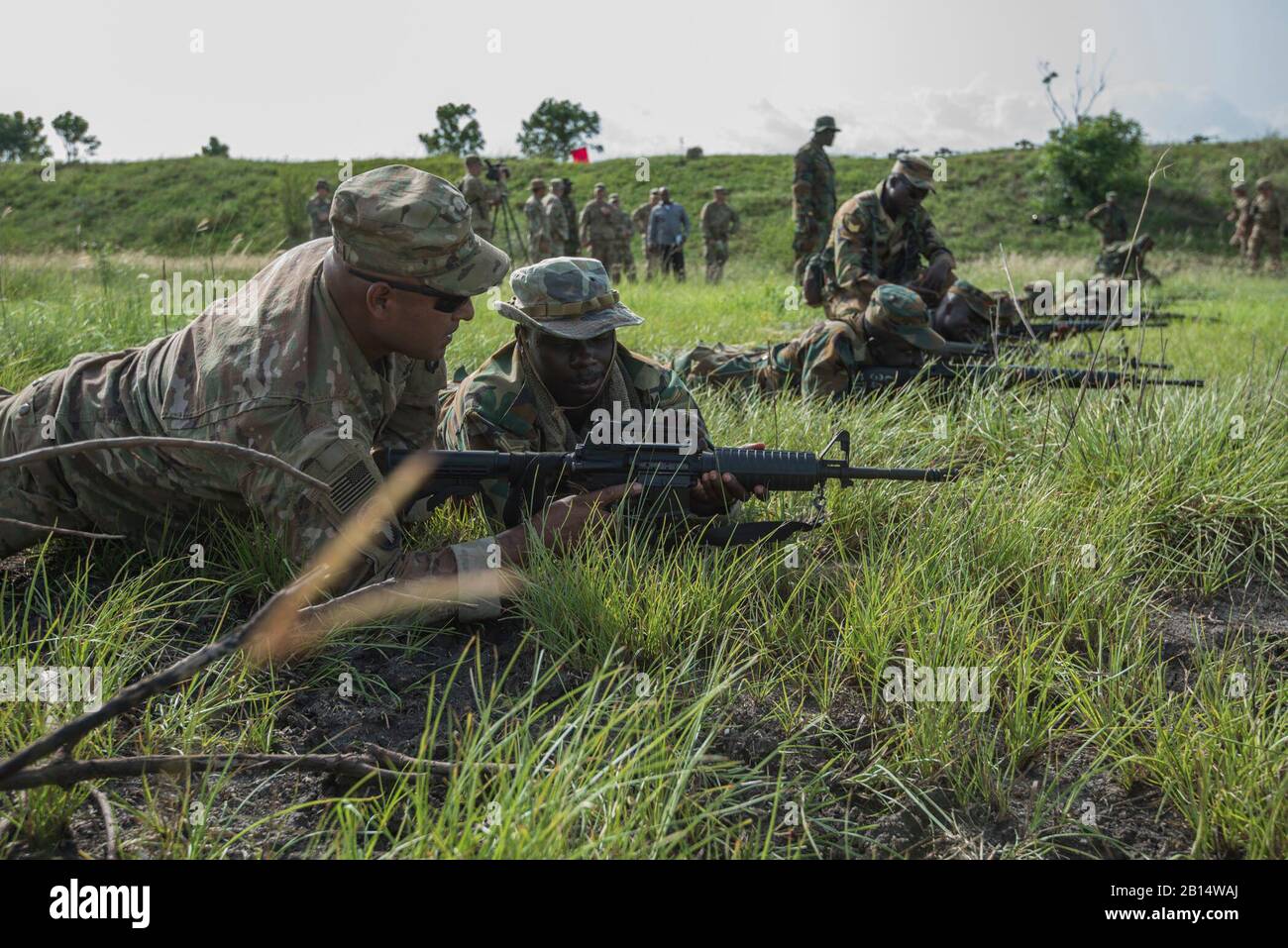 Ghana Armed Forces and U.S. Soldiers practice basic rifle marksmanship skills at the field training exercise during United Accord 2017 at the Bundase Training Center in Accra, Ghana, May 23 2017. United Accord (formerly Western Accord) 2017 is an annual, combined, joint military exercise that promotes regional relationships, increases capacity, trains U.S. and Western African forces, and further cross training and interoperability. (U.S. Army photo by Staff Sgt. Shejal Pulivarti) Stock Photo