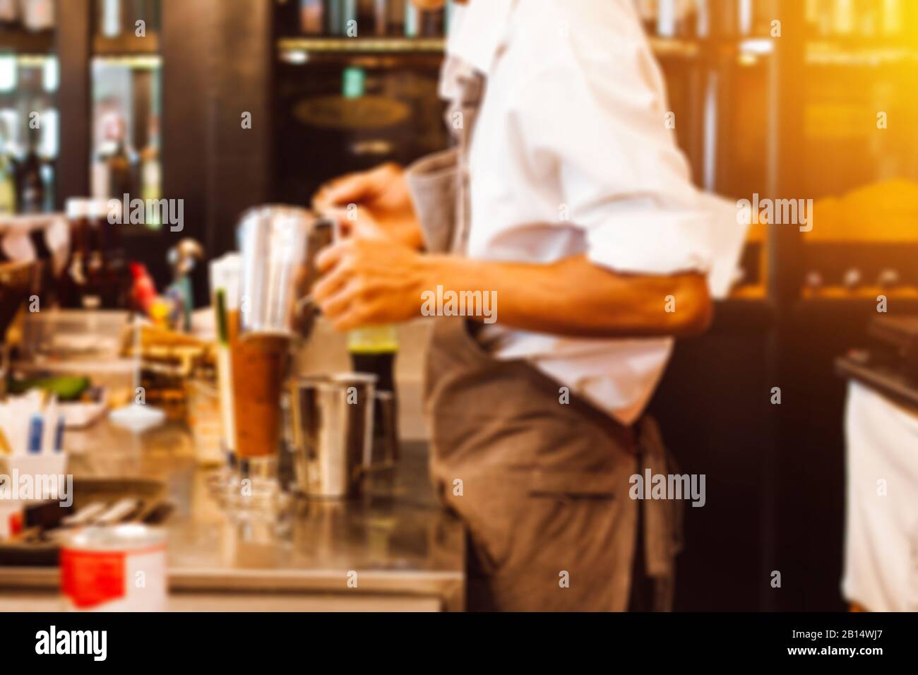 Abstract blur background of barista for coffee shop business background. Barista cafe coffee grinder pour professional concept. Stock Photo
