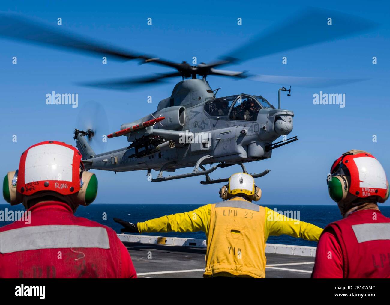 U.S. Sailors assigned to the San Antonio-class amphibious transport dock USS Anchorage (LPD 23), signal an AH–1Z Viper helicopter, attached to Marine Light Attack Helicopter detachment of Marine Medium Tiltrotor Squadron (VMM) 166, on the flight deck during composite training unit exercise (COMPTUEX) in the Pacific Ocean May 31, 2018. COMPTUEX is the final pre-deployment exercise which certifies the combined Essex Amphibious Ready Group and the 13th Marine Expeditionary Unit’s abilities to conduct military operations at sea and project power ashore during their upcoming deployment in summer of Stock Photo