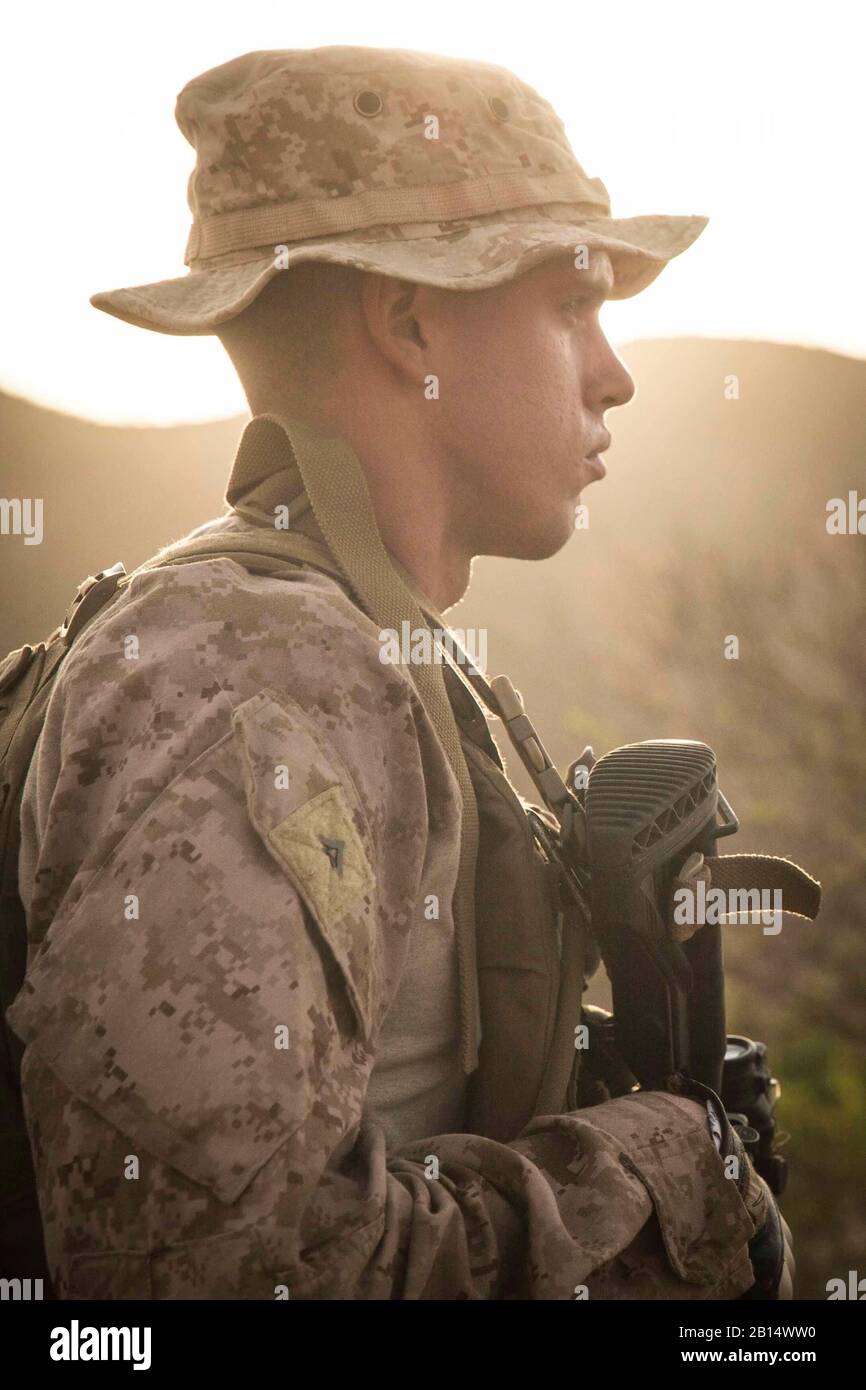 U.S. Marine Corps Lance Cpl. Riley Crider, a machine gunner assigned to Kilo Company, Battalion Landing Team 3/1, 13th Marine Expeditionary Unit, waits for orders during a fire team maneuver drill while participating in Theater Amphibious Combat Rehearsal (TACR) 18 in Djibouti Sept. 8, 2018. Led by Naval Amphibious Force, Task Force 51/5th Marine Expeditionary Brigade, TACR integrates U.S. Navy and Marine Corps assets to practice and rehearse a range of critical combat-related capabilities available to U.S. Central Command, both afloat and ashore, to promote stability and security in the regio Stock Photo