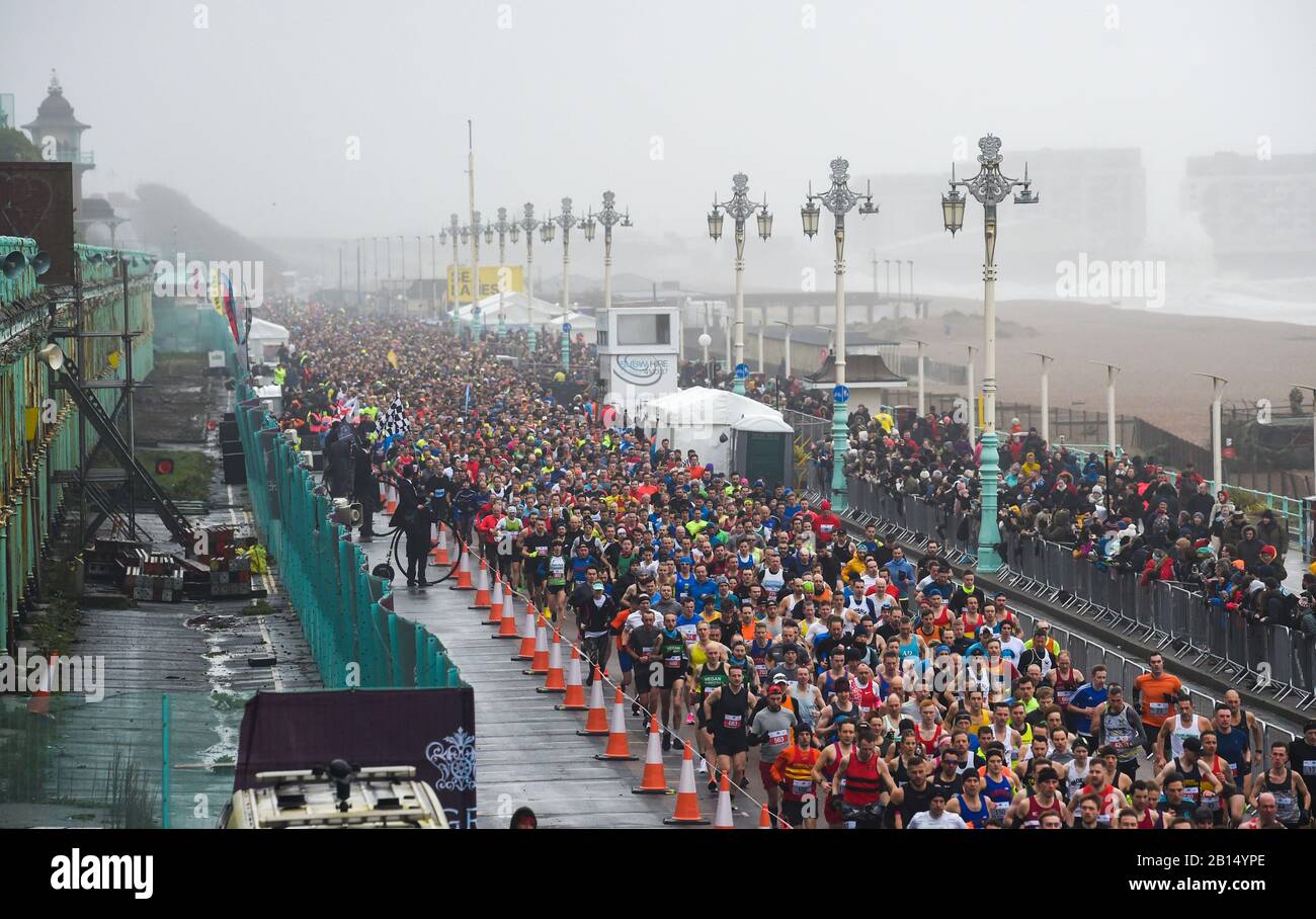 Brighton UK 23rd February 2020 - Thousands take part in The Grand Brighton Half Marathon in wet and windy weather conditions . Over ten thousand runners took part and this years official charity partners is The Sussex Beacon which provides specialist care and support for people living with HIV  : Credit Simon Dack / Alamy Live News Stock Photo