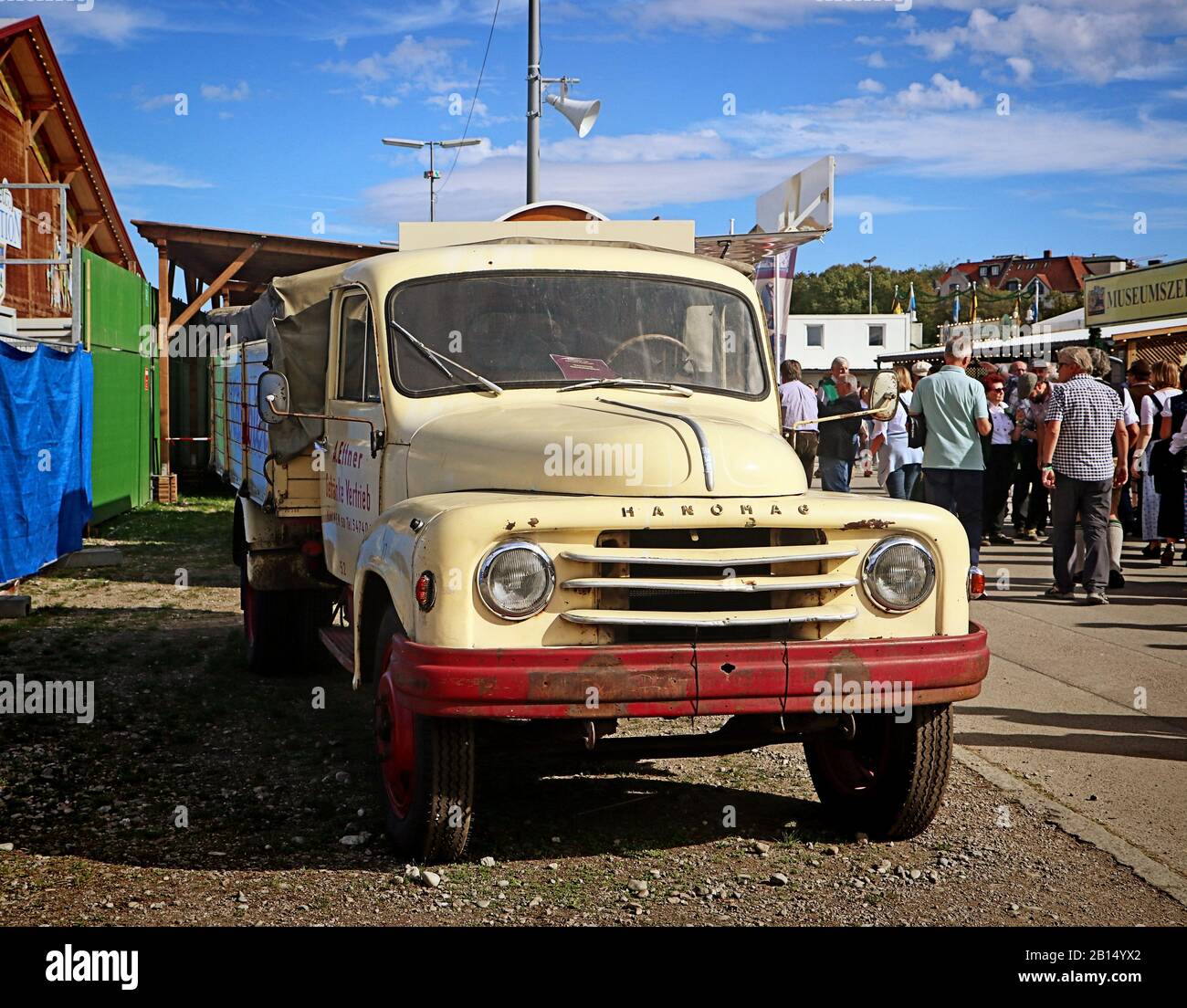 MUNICH, GERMANY - OCTOBER 1, 2019 Vintage Hanomag farm truck on display at Oide Wiesn historical part of the Oktoberfest in Munich,a family and child- Stock Photo