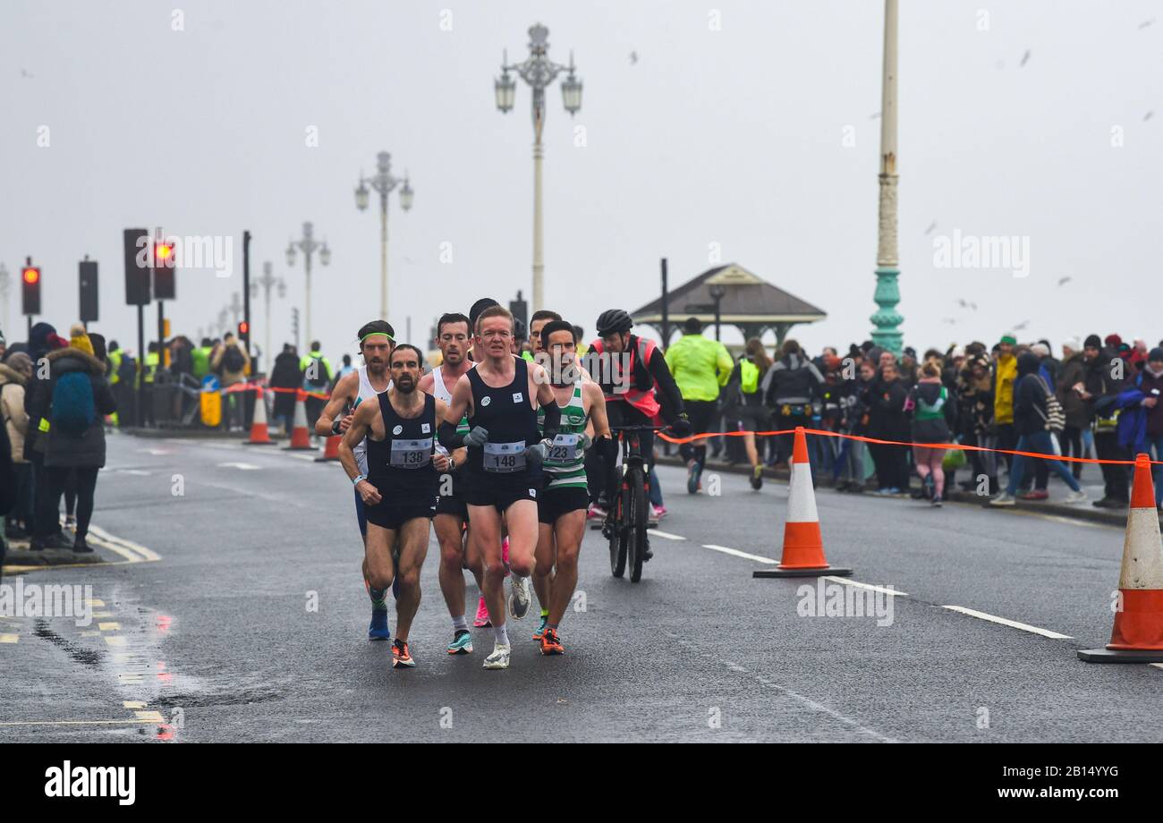 Brighton UK 23rd February 2020 - The early pace setters as thousands take part in The Grand Brighton Half Marathon in wet and windy weather conditions . Over ten thousand runners took part and this years official charity partners is The Sussex Beacon which provides specialist care and support for people living with HIV  : Credit Simon Dack / Alamy Live News Stock Photo