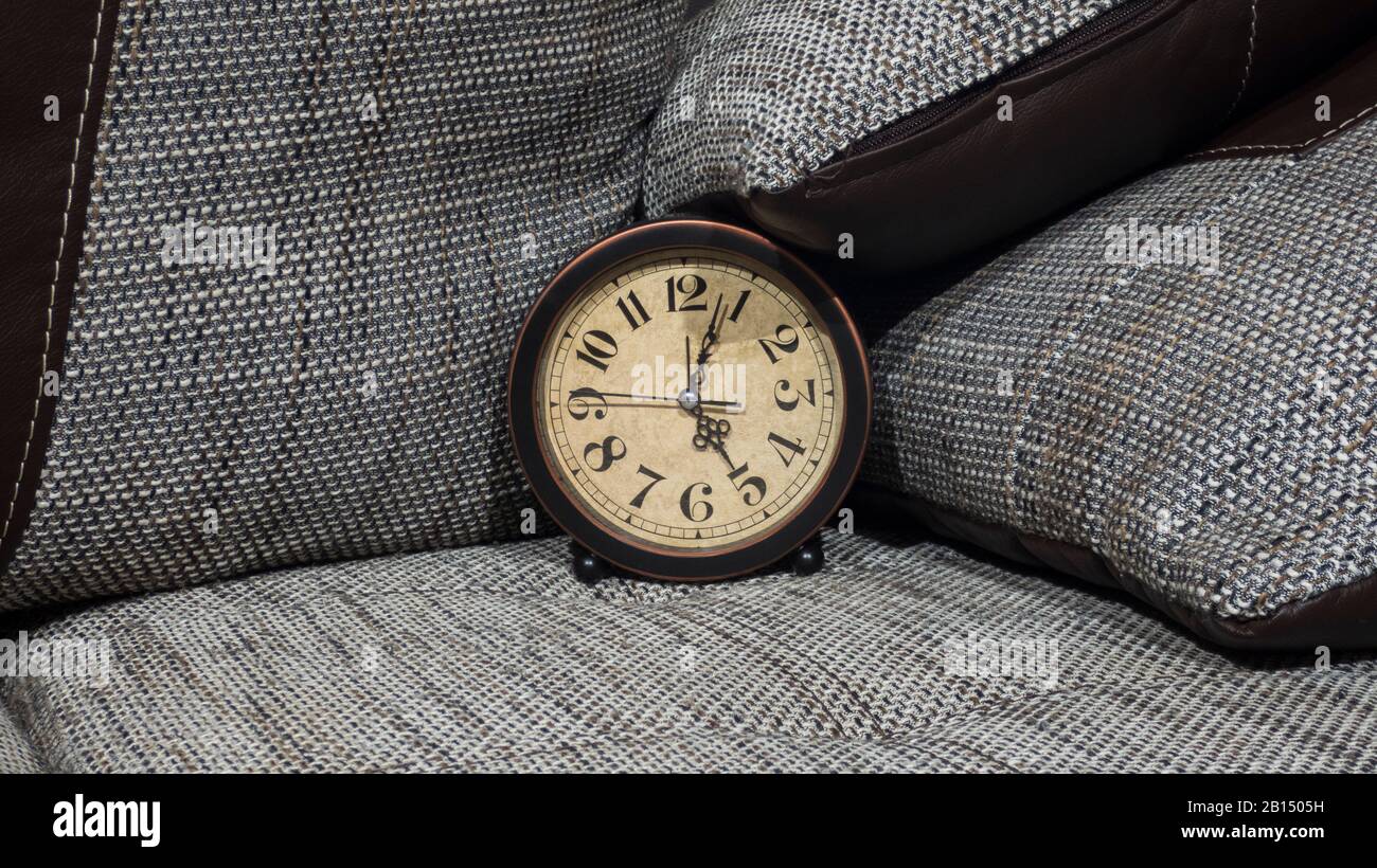 Summer Daylight Saving Time (DST) concept. Retro styled Clock with pillows. Stock Photo