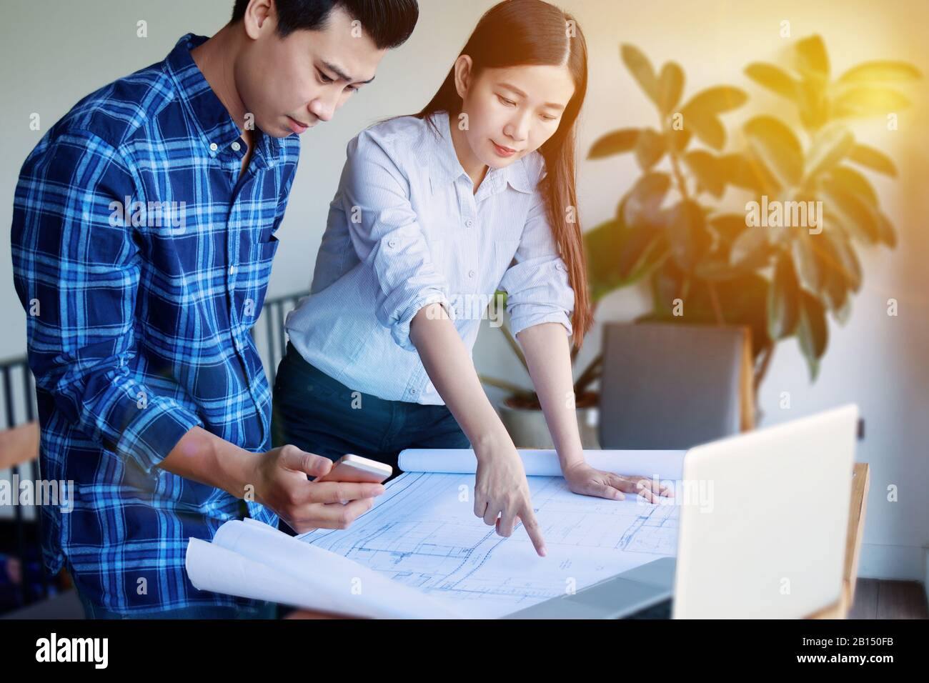 Construction , designer and renovate concept. - Architects working with blueprints in the office. Confident team of young Asian engineers working Stock Photo