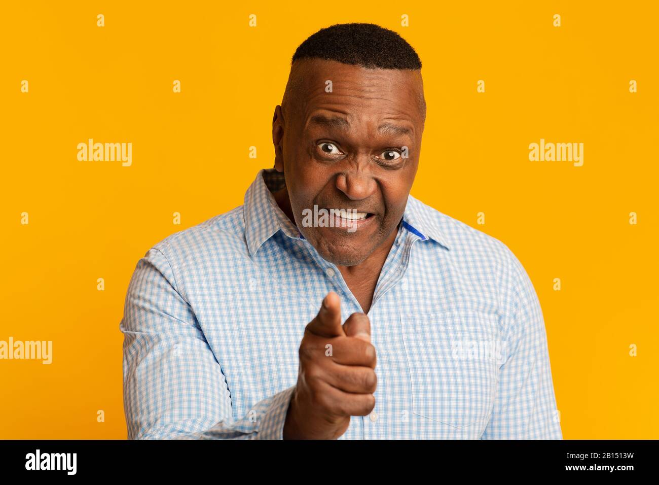 Angry middle aged african american man pointing at camera Stock Photo