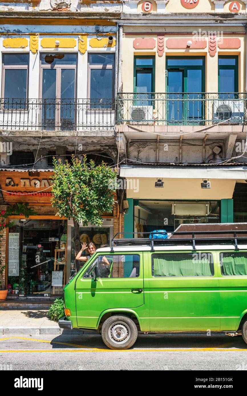 Kavala, Greece, 15/07/2019: Streets of ancient Greek city with old timer  camper van and young girl waving from the other side Stock Photo - Alamy