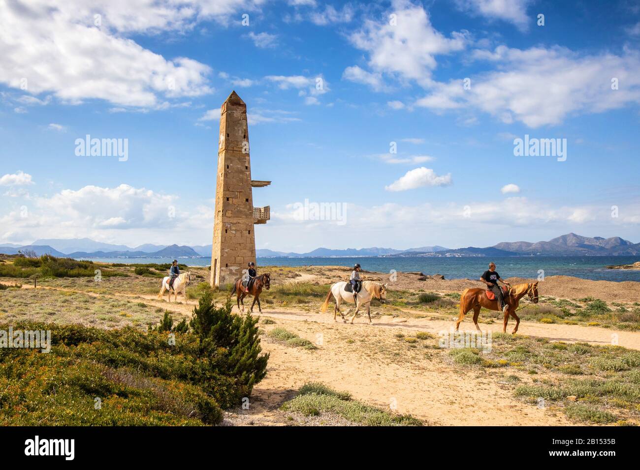 old watchtower by the sea and equestrian group, Balearic Islands, Majorca, Son Real, Can Picafort Stock Photo