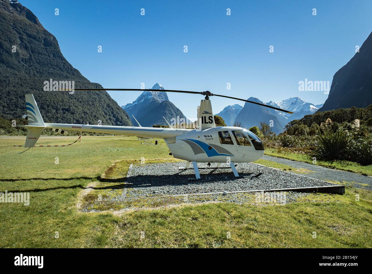 Robinson R44 Raven II helicopter from Heliworks of Queenstown parked up at Milford Sound Airport, New Zealand Stock Photo
