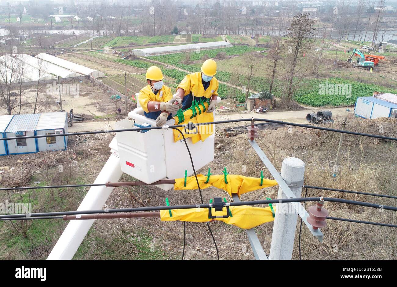 Chinese electricians perform live working on electric transmission