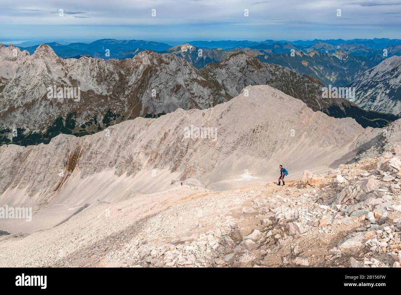 Hiker on hiking trail to the Birkkarspitze, scree field, Karwendeltal, Tyrol, Austria Stock Photo