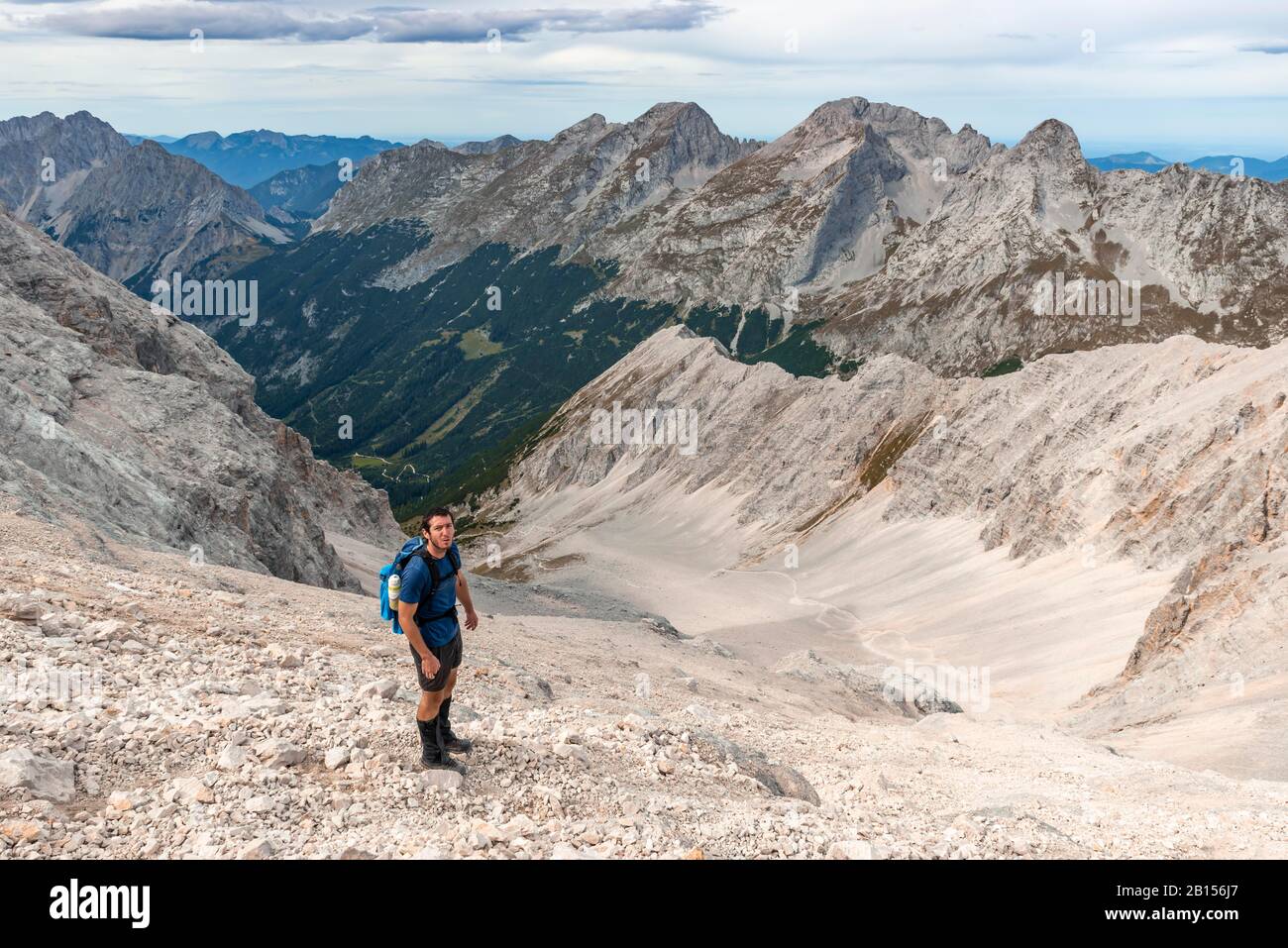 Hiker on hiking trail to the Birkkarspitze, scree field, Karwendeltal, Tyrol, Austria Stock Photo
