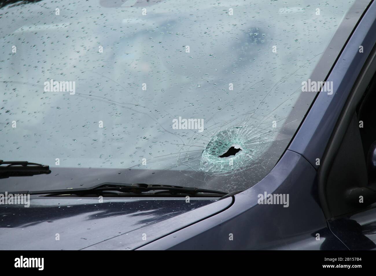 A Smashed Car Windscreen on a Wet and Rainy Day. Stock Photo