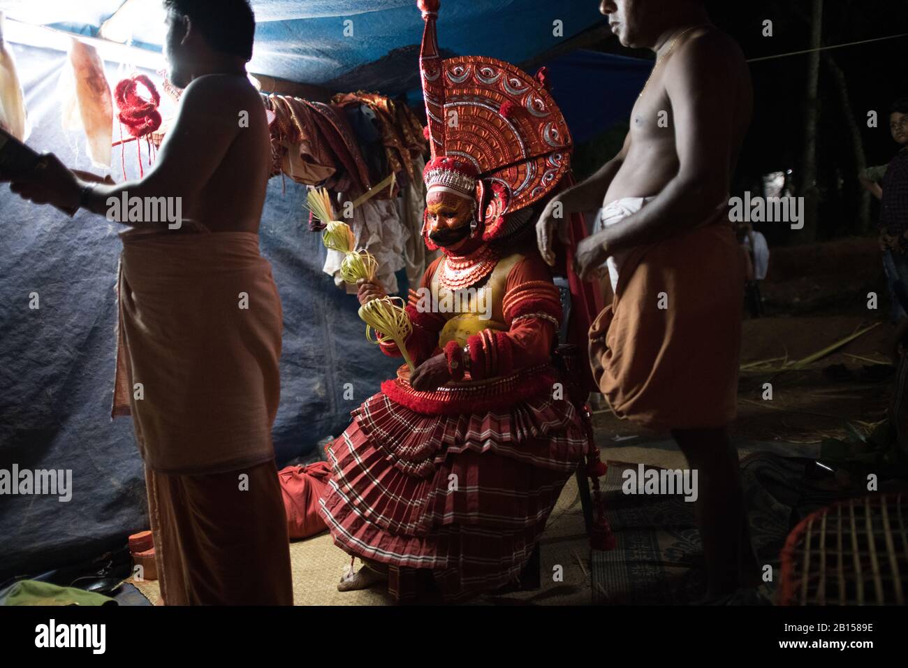 Preparing for Theyyam performance a popular ritual form of worship in