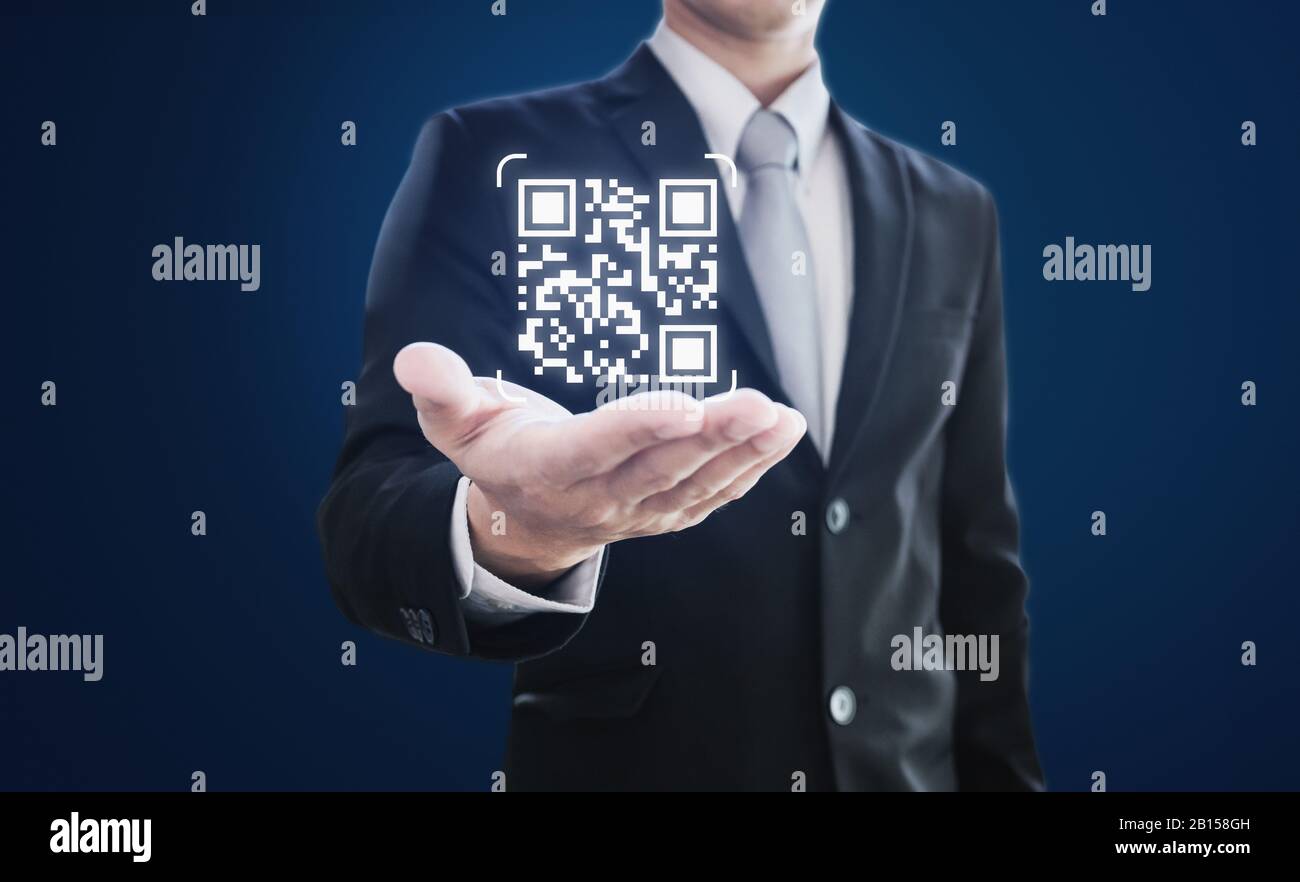 Businessman holding QR code on hand. QR code scanning payment and verification technology Stock Photo