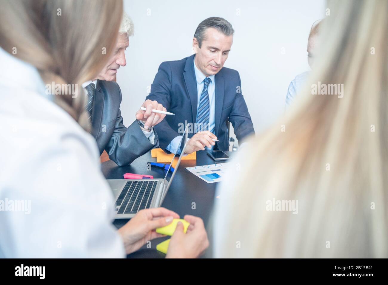 Working process at business meeting, group of people sitting around ...