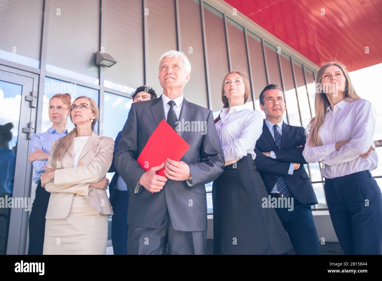 Successful Business People Standing Together and Looking at Their Bright Future Stock Photo
