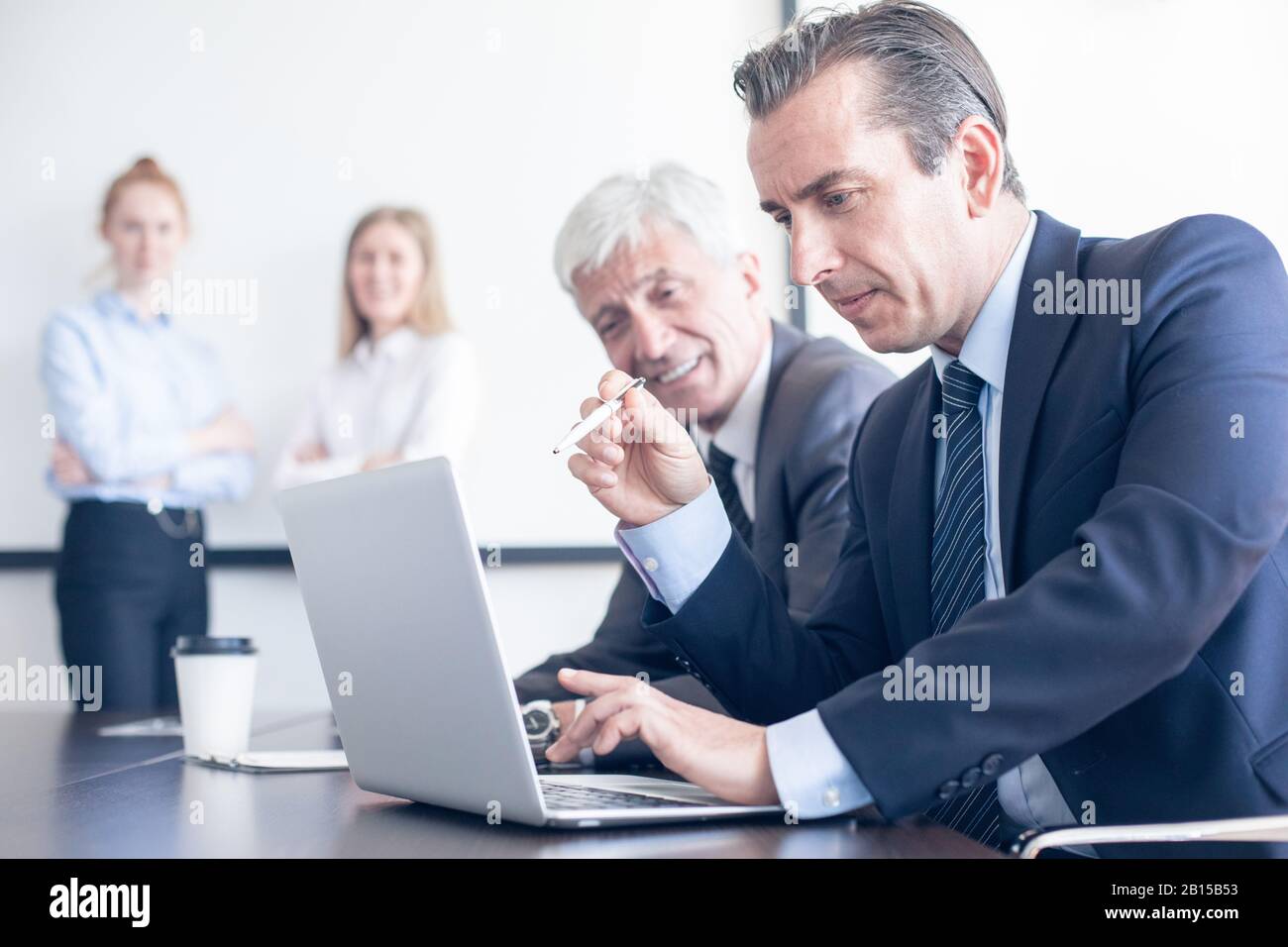 Business people working with laptop together in office Stock Photo