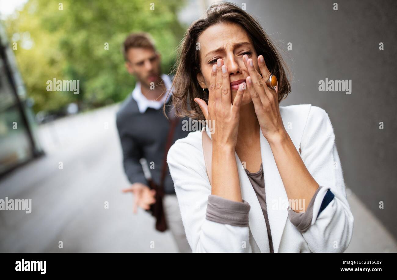 Breakup of couple with man and sad girlfriend outdoor. Divorce, couple, love, pain concept. Stock Photo