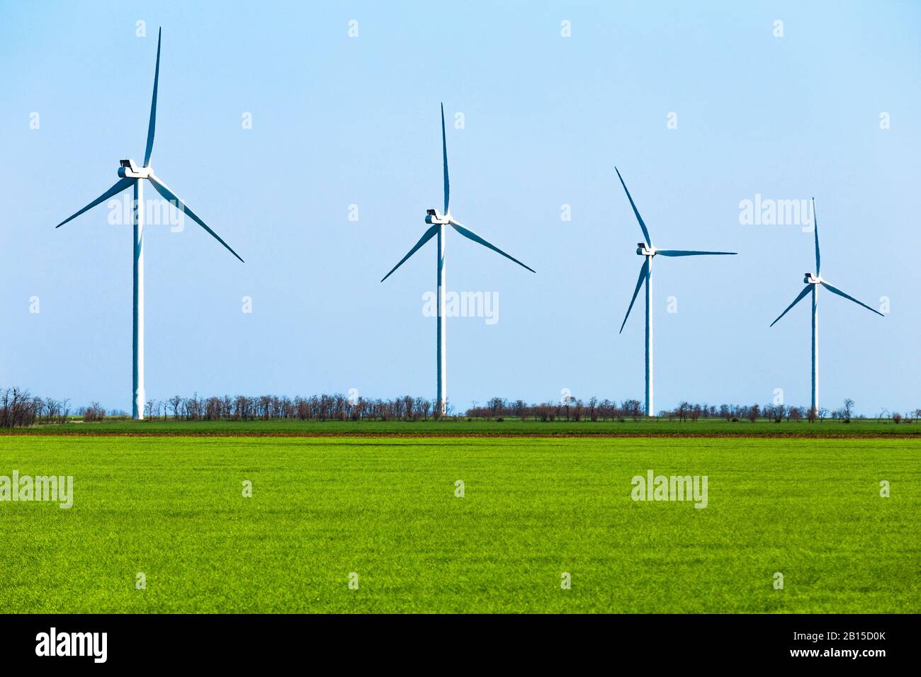 Huge wind turbines and bright colors of the meadow Stock Photo