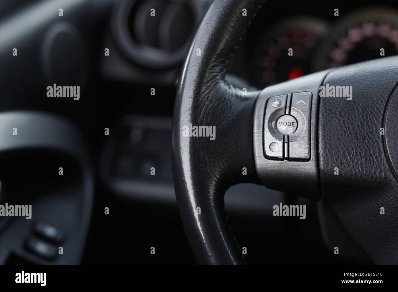 Control buttons on steering wheel in a modern car, close Stock Photo