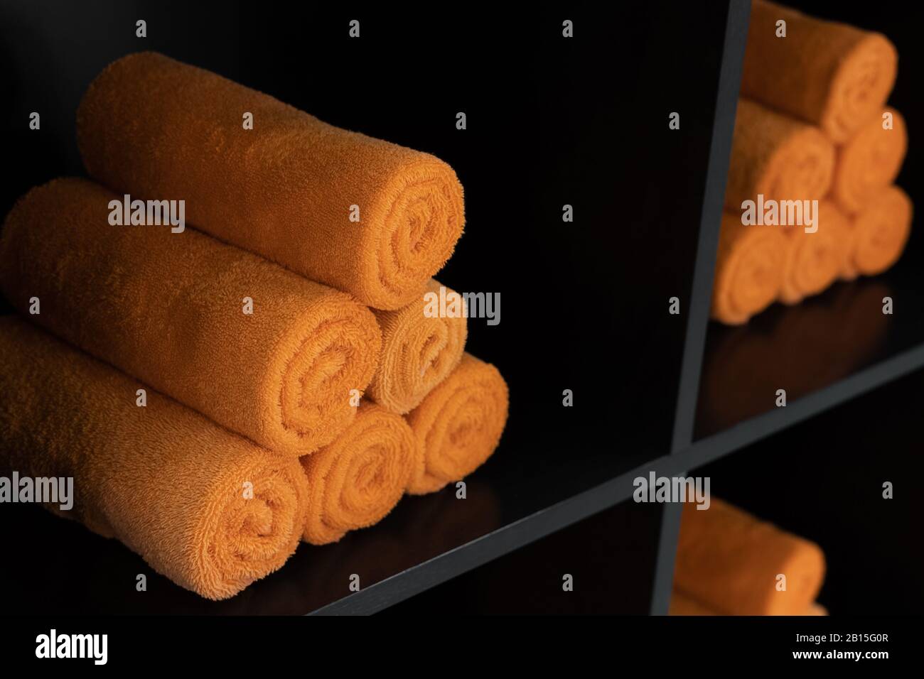 Lots of orange rolled towels on a shelves Stock Photo Alamy