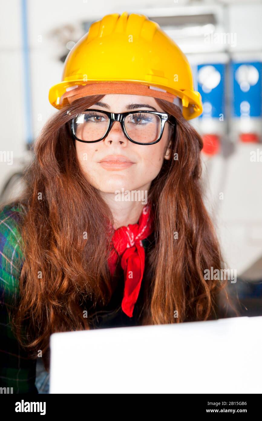 Pretty Engineers portrait of pretty engineer consult the computer in a steel mill Stock ...