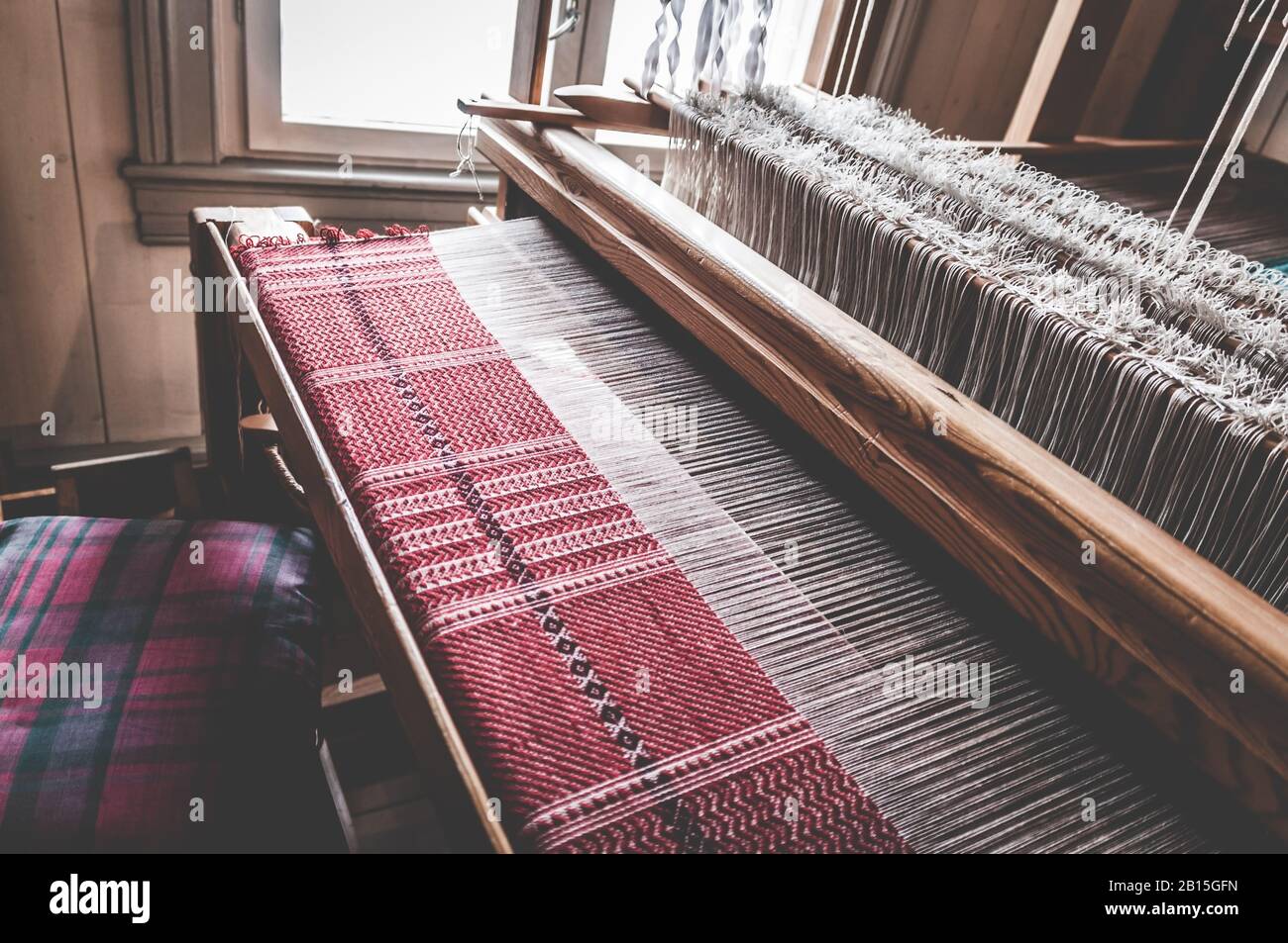 Traditional old vintage weaving loom as a professional handwork manufacturing tool for handmade weave production in a textile workshop. Stock Photo