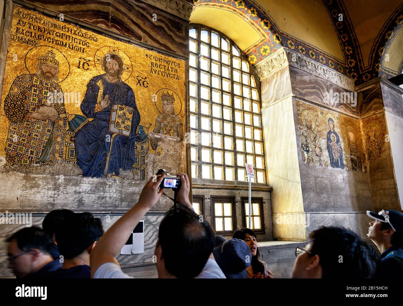 ISTANBUL - MAY 25, 2013: Tourists look at ancient mosaics in the church of Hagia Sophia. Hagia Sophia is the greatest monument of Byzantine Culture. I Stock Photo