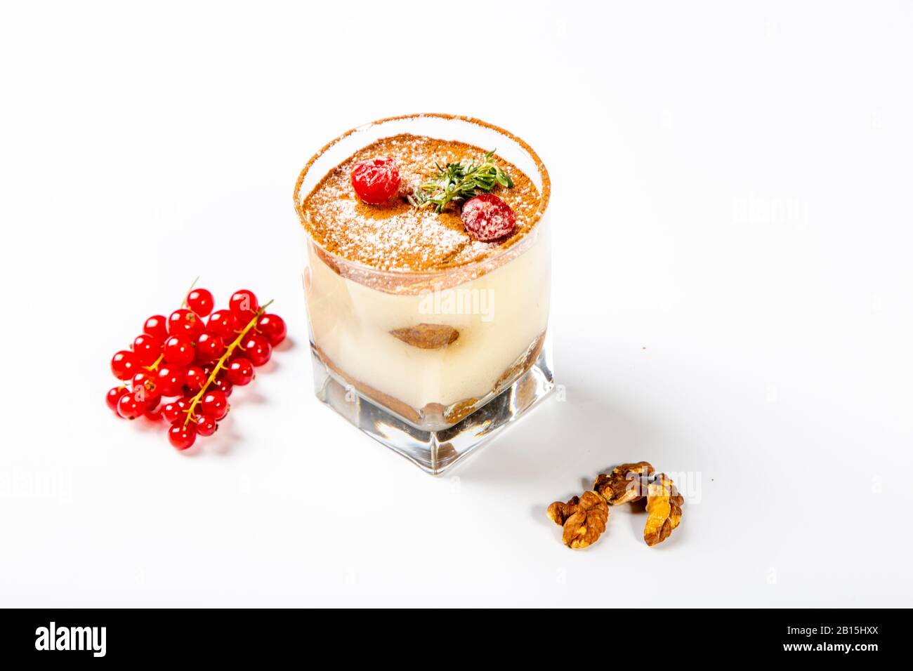 Panna cotta dessert in a clear glass. The dessert is decorated with
