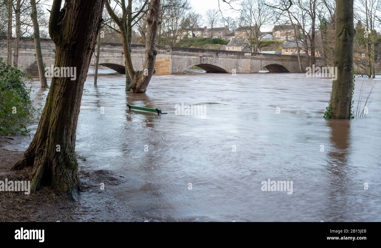 Flooded riverside path on the River Wharfe with high water levels flowing under Thorp Arch bridge at Boston Spa following Storm Dennis Stock Photo