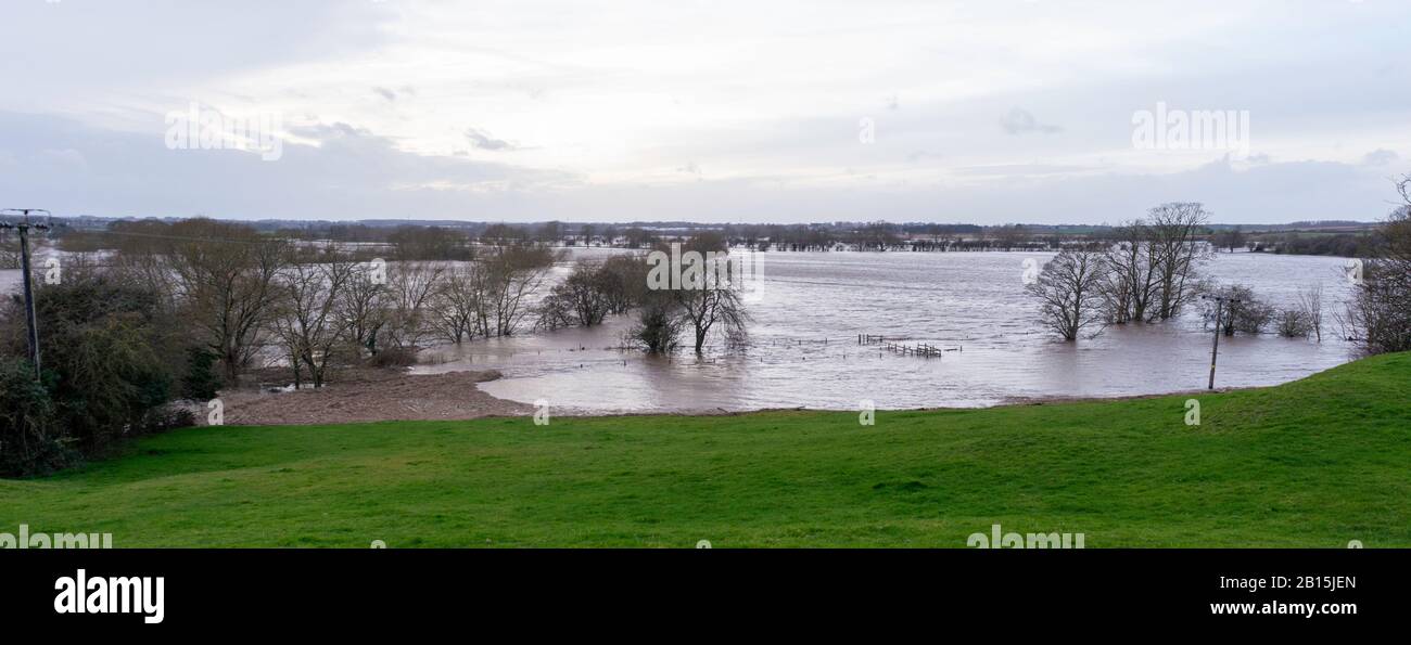 The River Wharfe bursts its banks and covers riverside meadows at Easdike near Tadcaster, North Yorkshire Stock Photo
