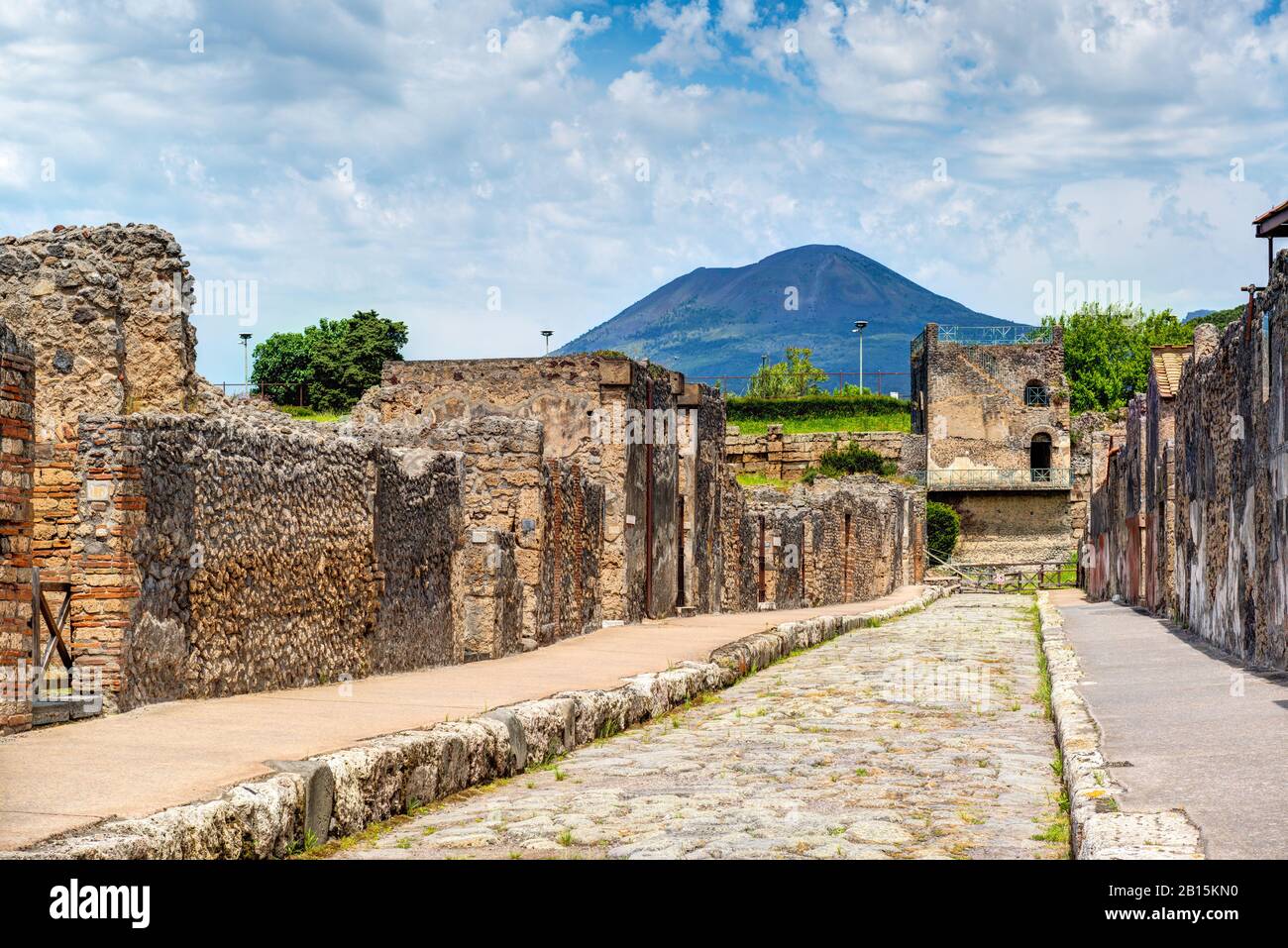 Street in Pompeii overlooking the Vesuvius. Pompeii is an ancient Roman city died from the eruption of Mount Vesuvius in 79 AD. Stock Photo