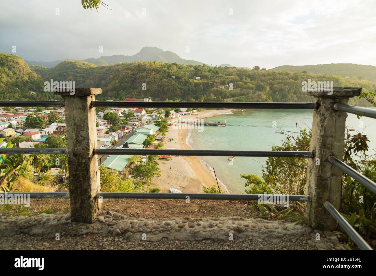 Enchanting rural fishing village of Anse La Raye in focus in the background and a popular view point out of focus in the foreground Stock Photo