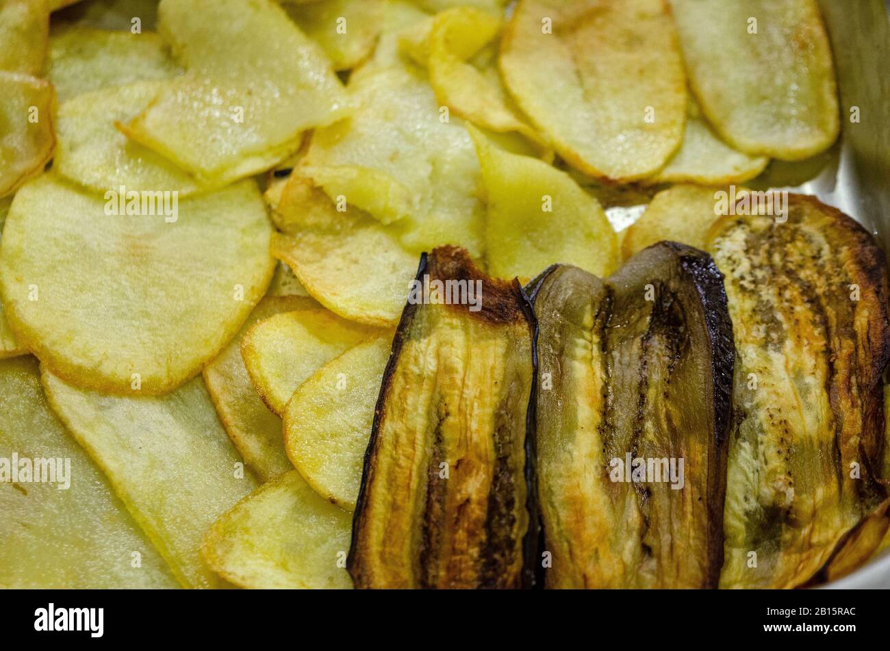 Eggplants baked on paper in a baking tray Stock Photo