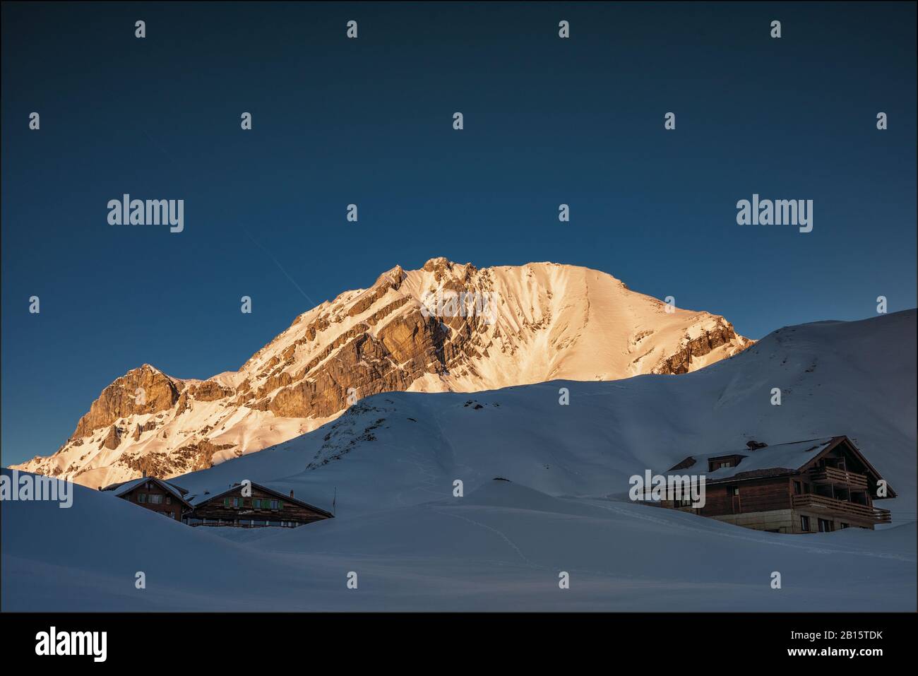 Engstligenalp with chalets and Lohner in the evening sun, Adelboden, Switzerland Stock Photo