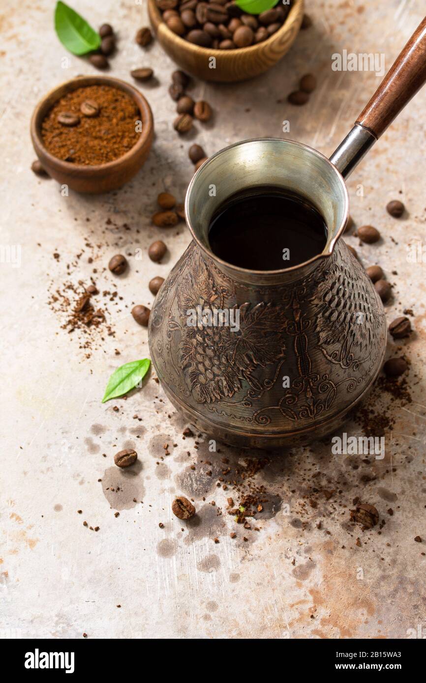 Morning coffee concept. Turkish coffee in Turk and coffee beans on a stone or slate countertop. Copy space. Stock Photo