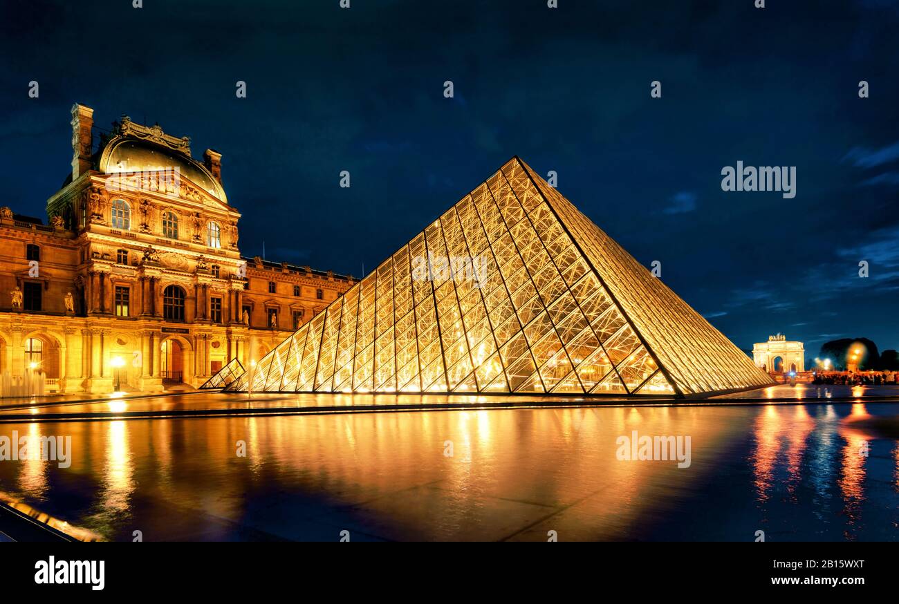 PARIS - SEPTEMBER 25, 2013: Louvre museum at night. The Louvre is one of the largest museums in the world and one of the major tourist attractions of Stock Photo