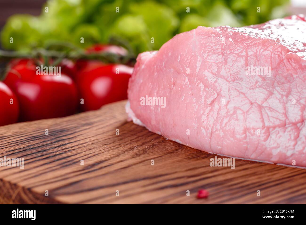 Fresh pieces pork ready to cook on a dark background in the kitchen