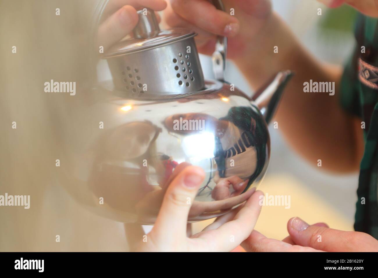 Girl holding a kettle Stock Photo Alamy