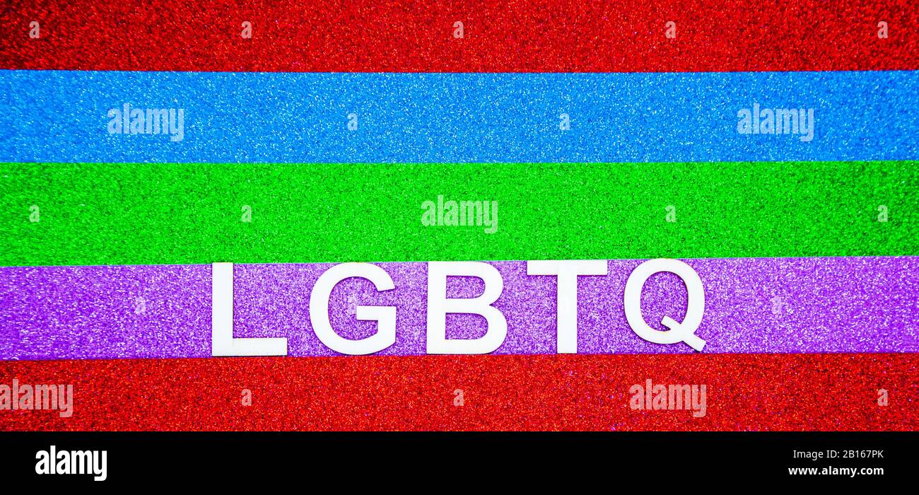 LGBTQ writen on glittery rainbow coloured background Stock Photo