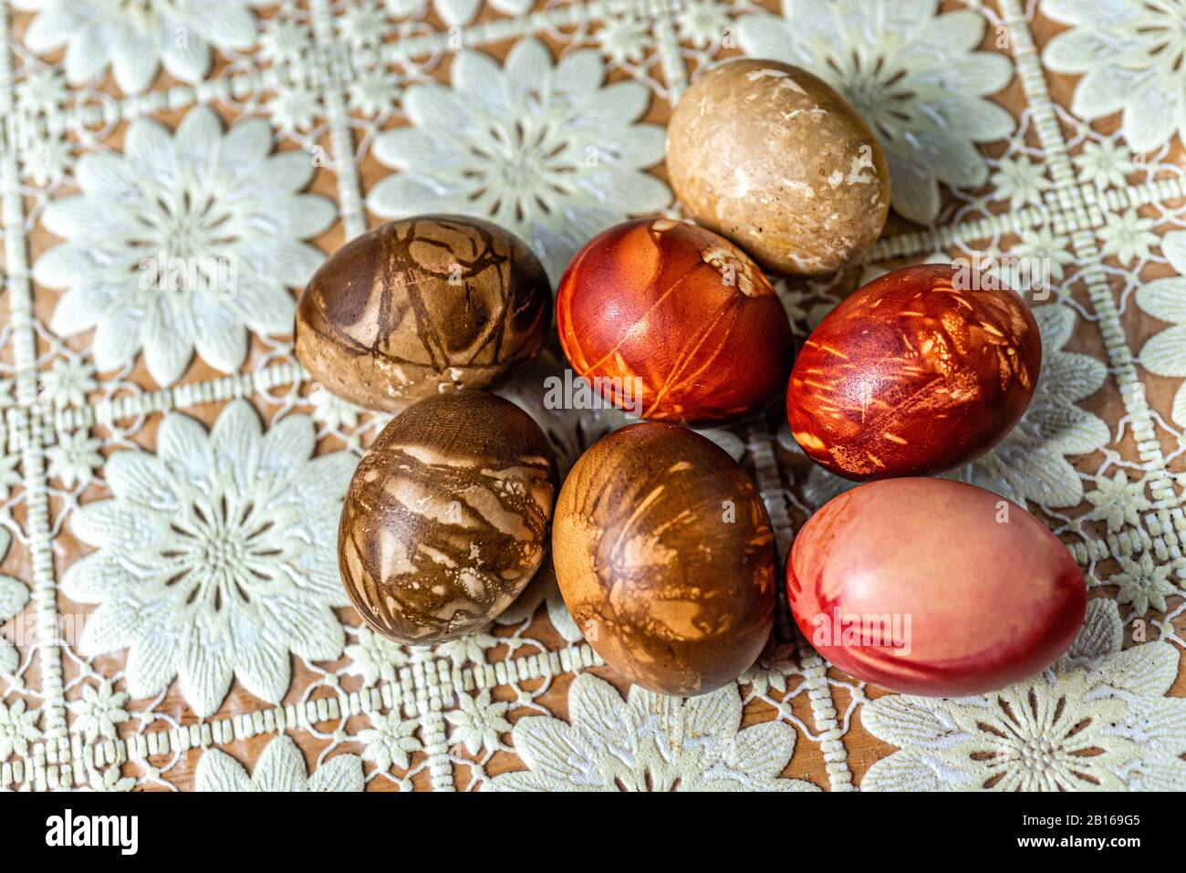 Multicolored easter eggs on a picnic table with a white tablecloth - image Stock Photo