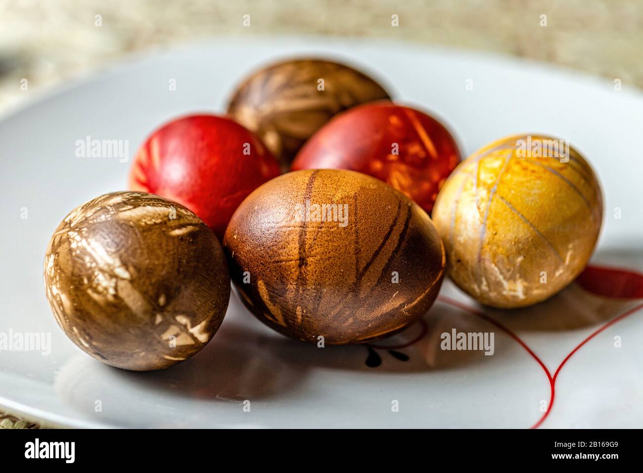 Multicolored easter eggs on a picnic table with a white tablecloth - image Stock Photo