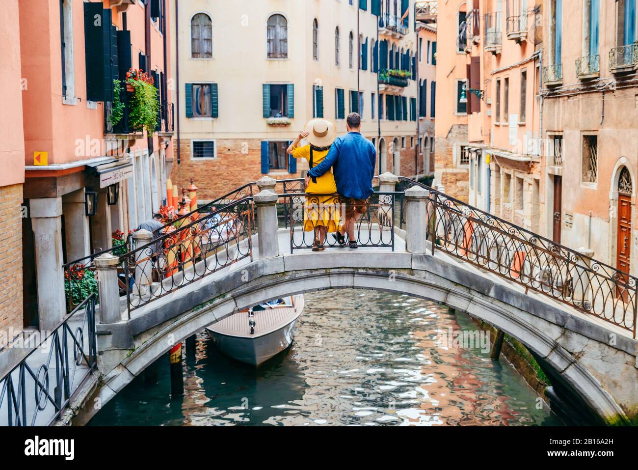 couple standing on the bridge crossing venice canals Stock Photo