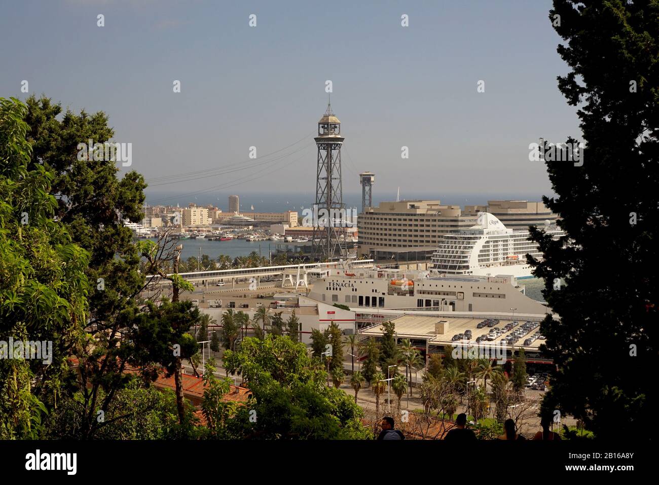 A view of Port Vell and tramway tower Barcelona from high up through the trees Stock Photo