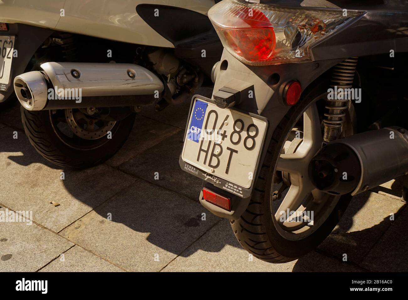A motorbike registration plate showing a Catalan sticker over the top of the Spanish emblem displaying desire for independence Stock Photo